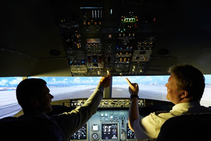 a man standing in front of a computer